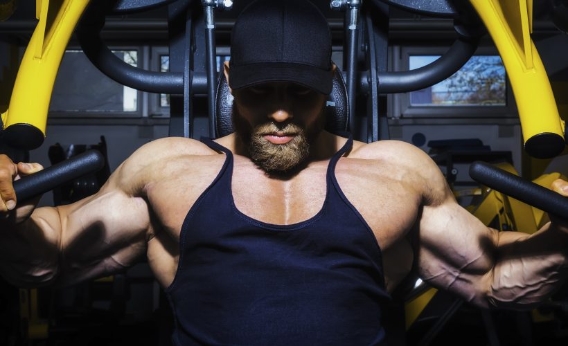 chest workout plan man using a chest press machine