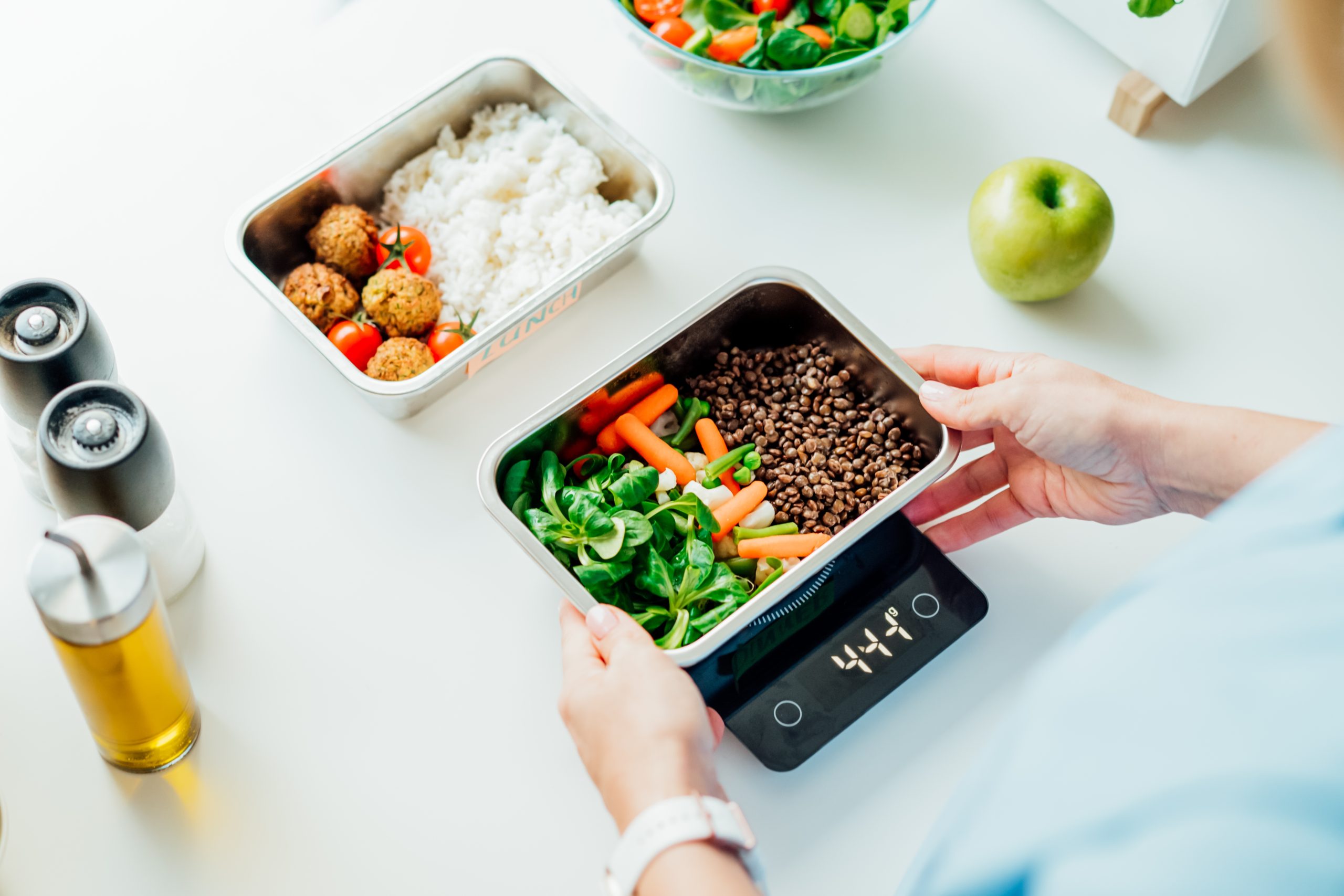 weight loss meal plan woman measuring her food on a sale while meal prepping